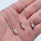 Hand holding cushion cut, marquise, and fancy cut lab grown diamond pendant necklaces.