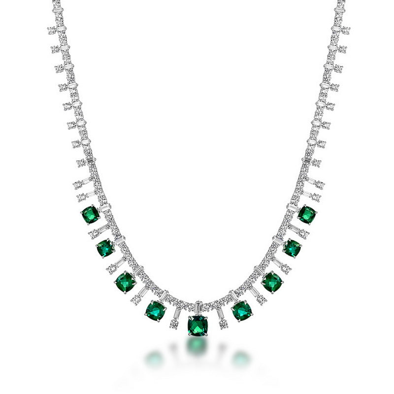 Cushion-cut emerald fringe statement necklace in sterling silver, studio white background.