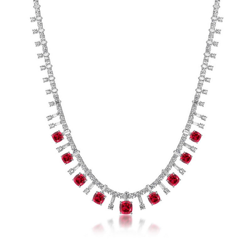Cushion-cut ruby fringe statement necklace in sterling silver, studio white background.