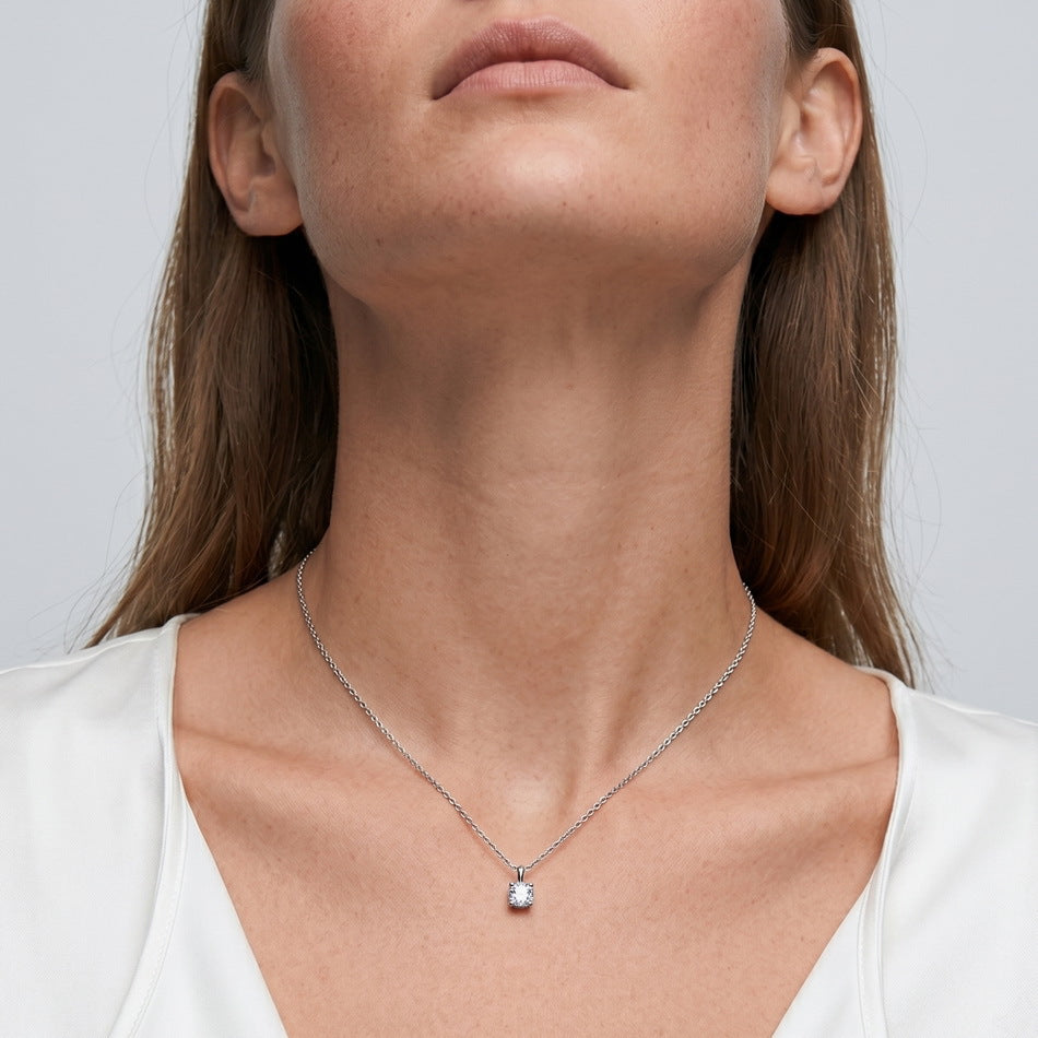 Model wearing cushion cut lab grown diamond solitaire pendant necklace.