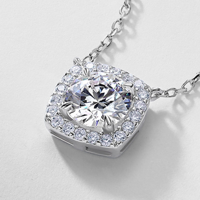Close-up view of openwork gallery and integrated chain on cushion halo diamond pendant.
