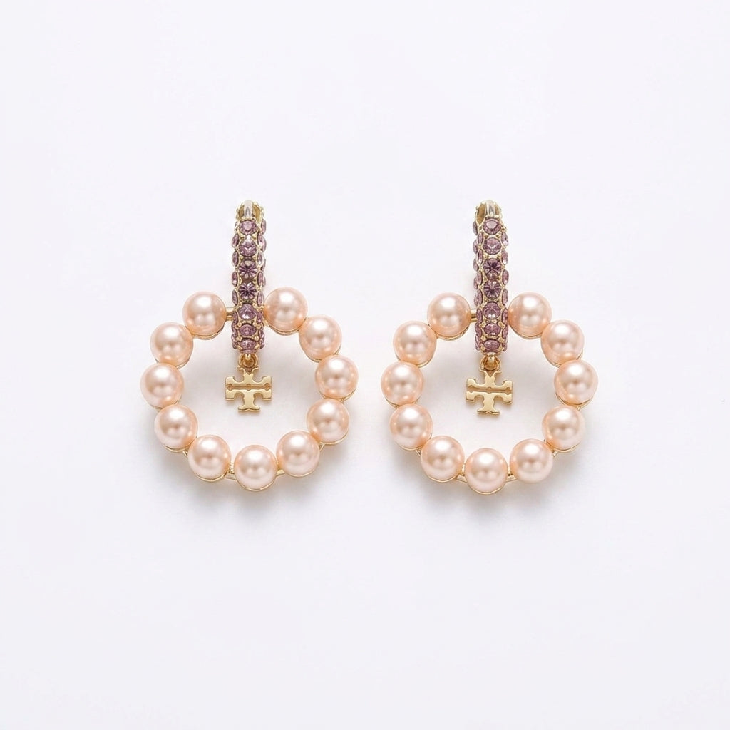 White background pure e-commerce studio view of premium designer style crystal double T logo pearl hoop earrings.