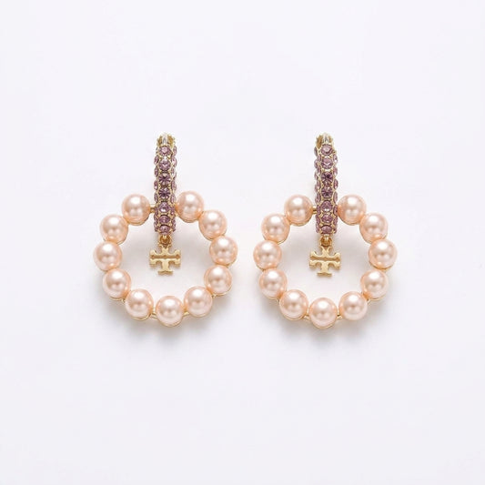 White background pure e-commerce studio view of premium designer style crystal double T logo pearl hoop earrings.