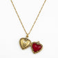 Detailed view of the functional and reversible Disney x Kendra Scott Snow White heart locket open to show the vintage gold interior and back engraving.