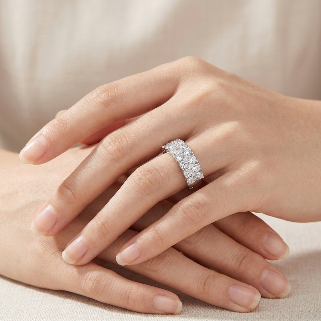 Close-up of a woman's hand wearing the double row moissanite wedding band ring.