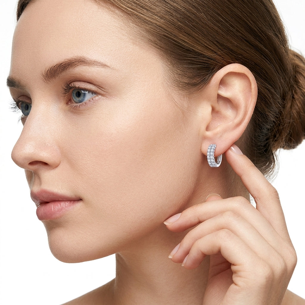 Model showing double row moissanite pave huggie hoop earrings on ear.