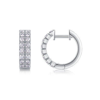 Double row moissanite huggie hoop earrings with pave hinged sleeper closure on white background.