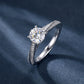Angled view of round cut double row pavé engagement ring on dark silk background.