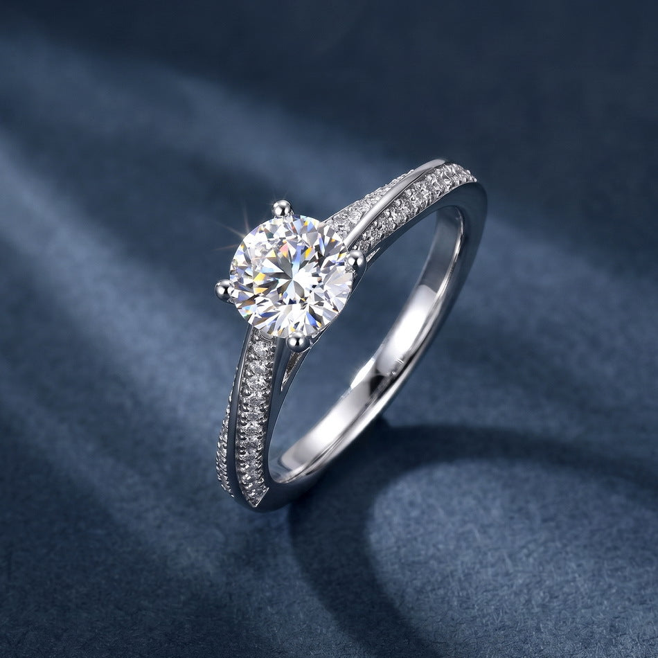 Angled view of round cut double row pavé engagement ring on dark silk background.