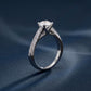 Side profile view of round cut engagement ring showing high prong gallery and split shank.