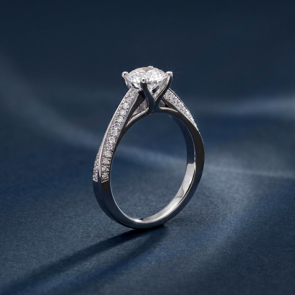 Side profile view of round cut engagement ring showing high prong gallery and split shank.