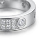 Macro close-up shot of the double row pavé moissanite stones and bezel setting on a silver eternity band.
