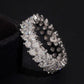 Angled view of double row round moissanite full eternity band ring on dark background