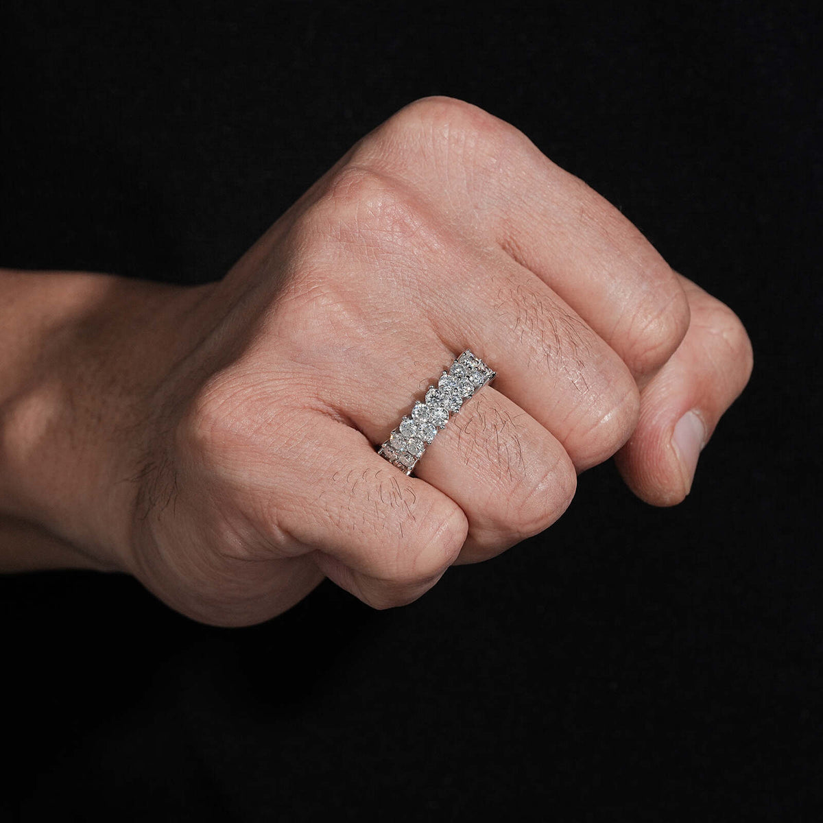 Woman wearing double row round moissanite full eternity ring on finger