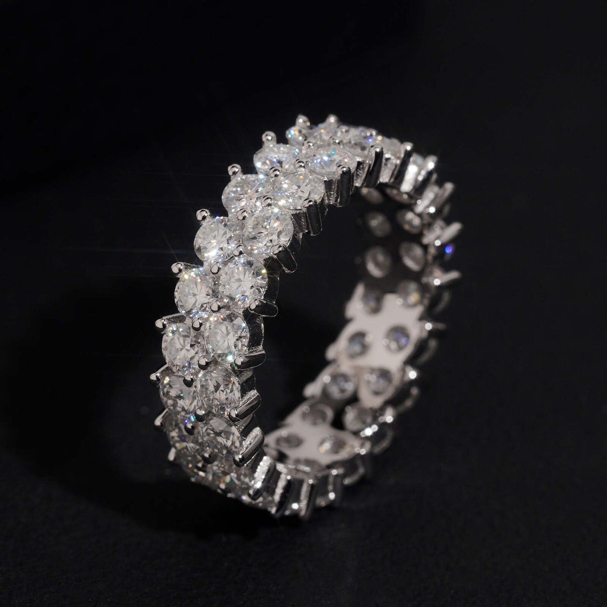 Close up side view showing prong setting of double row round moissanite full eternity ring