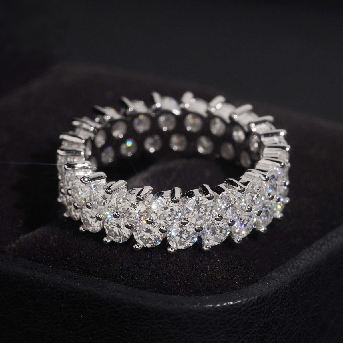 Double row round moissanite full eternity ring in sterling silver on black jewelry box