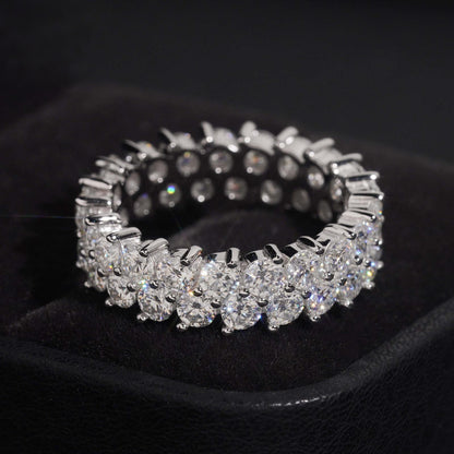 Double row round moissanite full eternity ring in sterling silver on black jewelry box