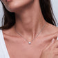 Model wearing East-West emerald cut lab grown diamond solitaire pendant necklace.