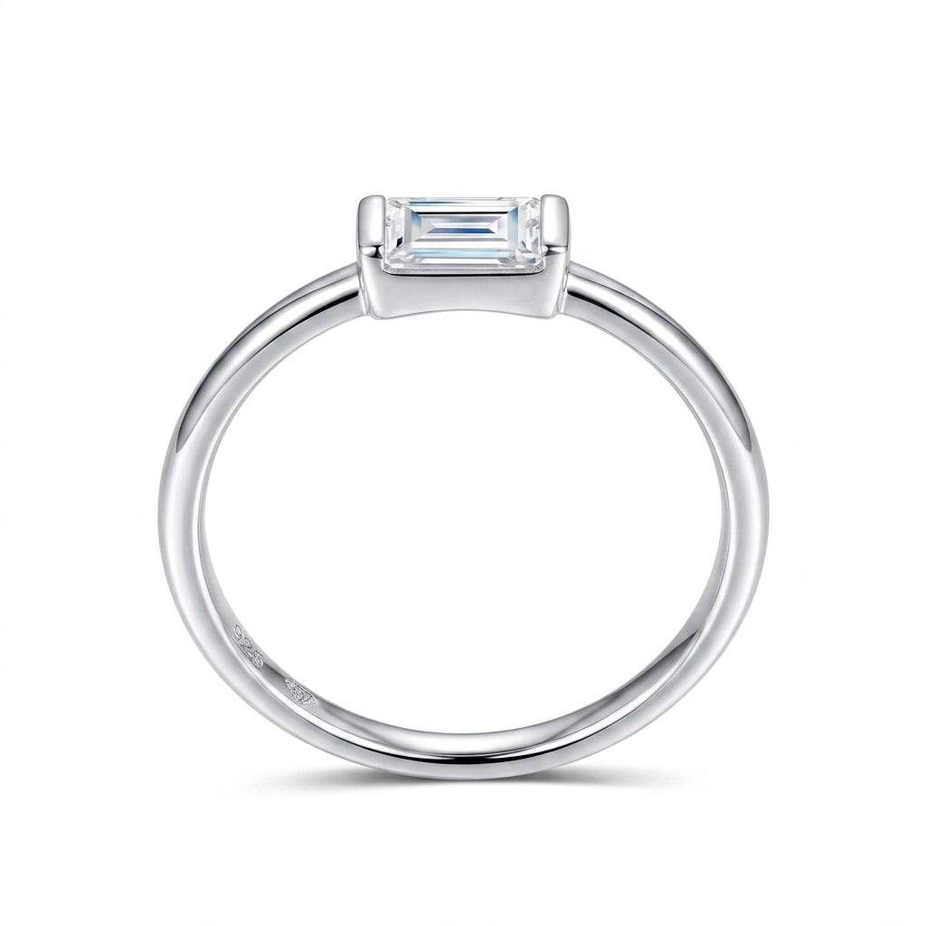 Side profile view showing low-profile East-West bezel set emerald moissanite stone.