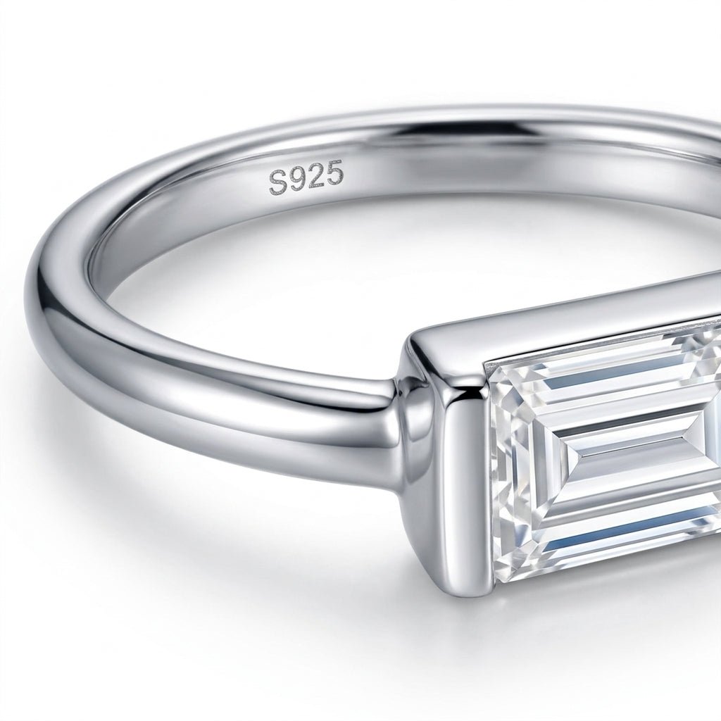 Macro detail view showing full bezel frame and S925 hallmark on East-West moissanite ring.