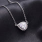 Close up view showing micro pave halo and horizontal pear cut moissanite pendant   