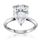 Front view of the east-west set pear moissanite teardrop solitaire ring on white background.