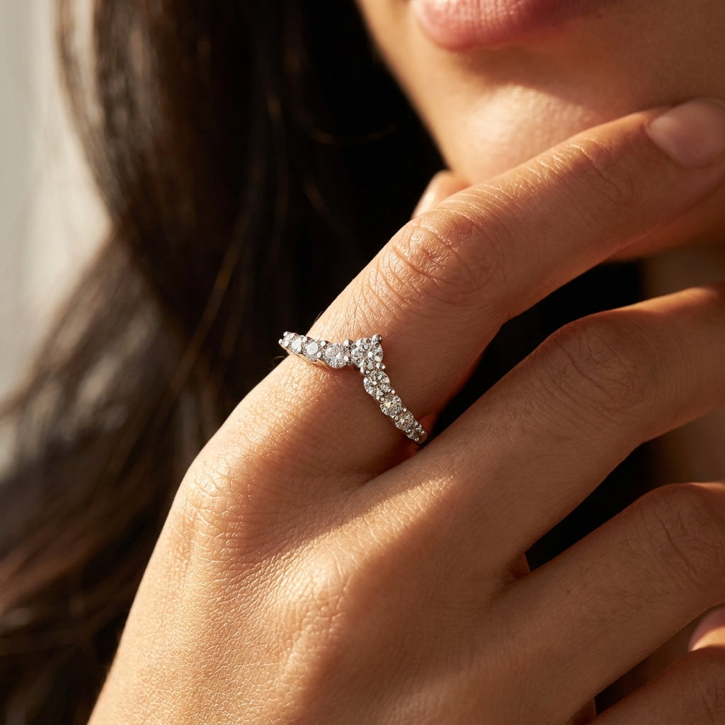 High-end fashion lookbook view of a model wearing an editorial style v shaped moissanite enhancer ring near her face.