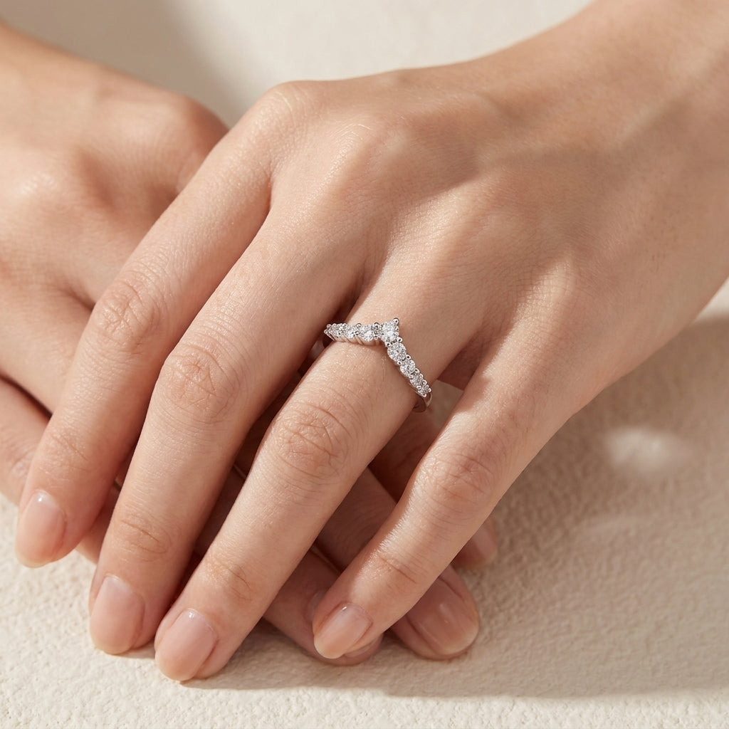 Closeup lookbook wear shot of a model's hands gracefully displaying an effortless luxury minimalist round gemstone crown stacker ring.