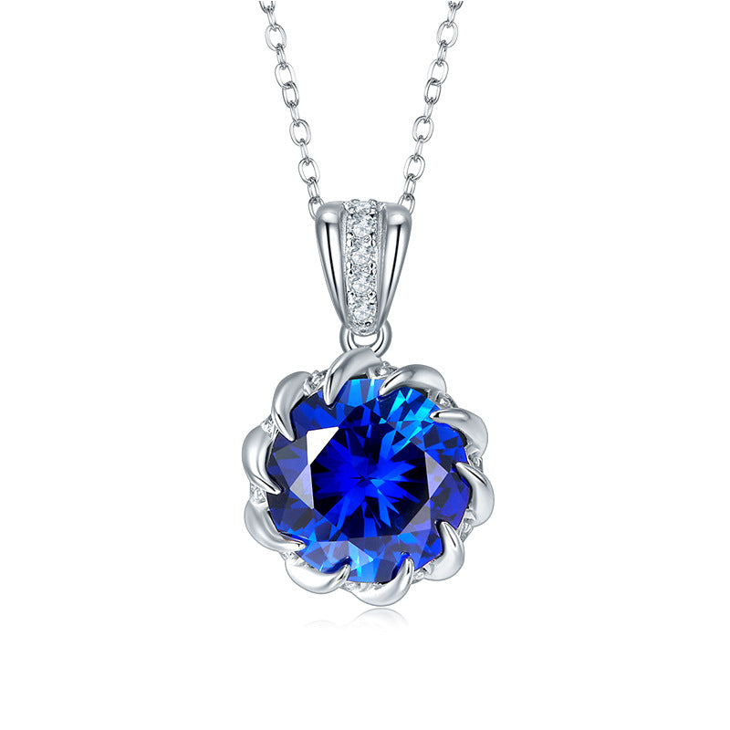 Elegant decorative bail round blue sapphire floral crown pendant necklace in sterling silver, white background.