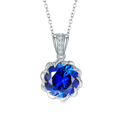 Elegant decorative bail round blue sapphire floral crown pendant necklace in sterling silver, white background.