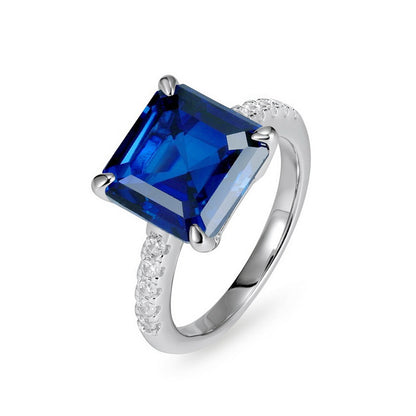 Elegant minimalist square blue sapphire statement ring for women featuring a large radiant asscher-cut blue gemstone.