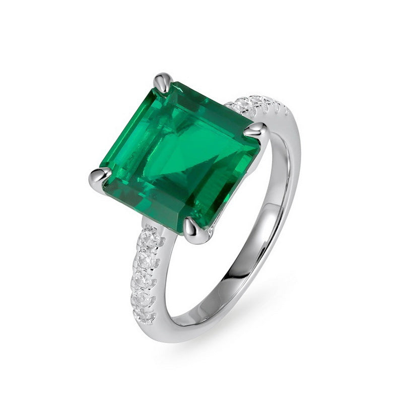 Elegant minimalist square emerald statement ring for women featuring a large radiant asscher-cut green gemstone.