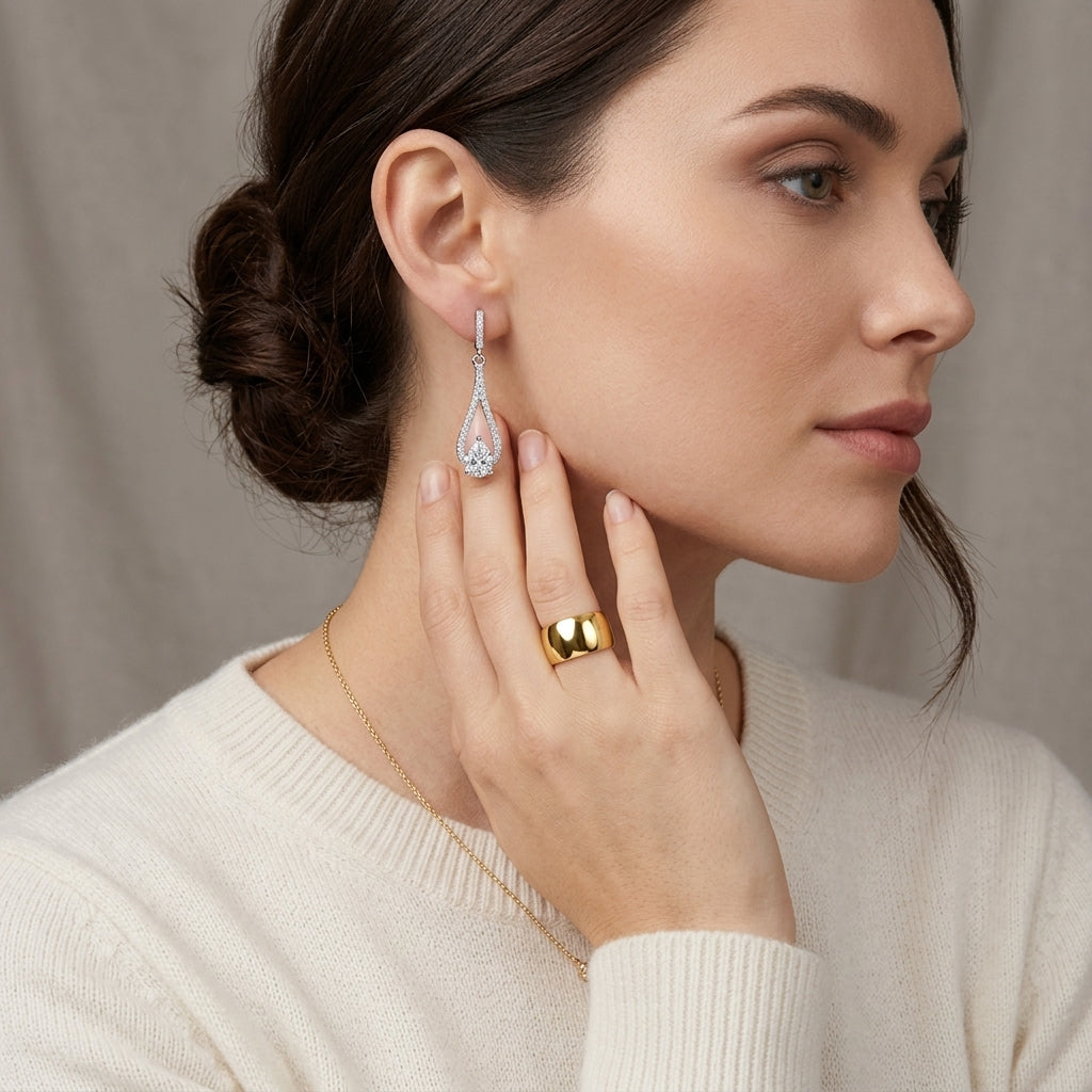 Woman wearing elegant pear cut lab grown diamond teardrop dangle earrings