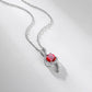 Elegant round-cut ruby treble clef pendant necklace displayed on a soft shaded white surface.