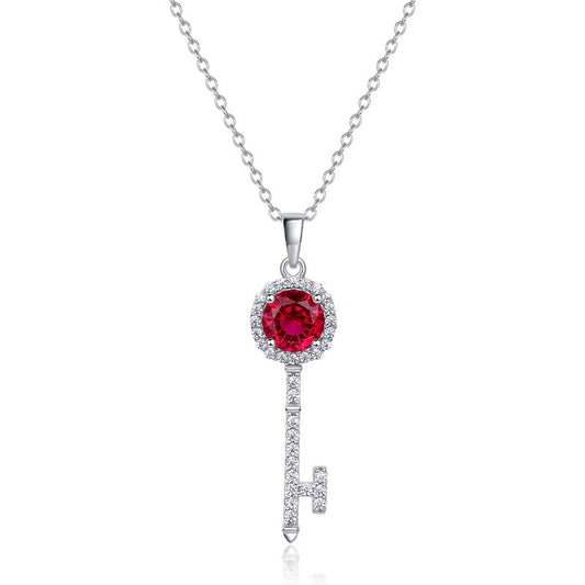 Elegant ruby secret sovereign key pendant necklace featuring a round-cut red gemstone with diamond halo.