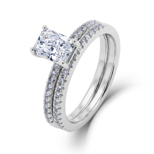 Elongated radiant cut lab diamond solitaire with micro pave shank and matching stacking ring set in 925 sterling silver.