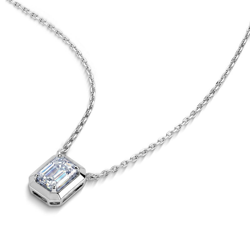 Angled view of emerald cut bezel-prong solitaire pendant with delicate cable chain.