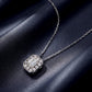 Emerald cut diamond octagonal halo bezel pendant displayed on navy blue background.