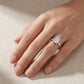 Model wearing emerald cut lab grown diamond hidden halo engagement ring.