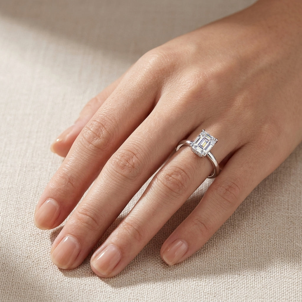 Model wearing emerald cut lab grown diamond hidden halo engagement ring.