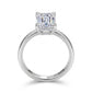Straight-on view of emerald cut lab grown diamond ring showing hidden halo collar setting.