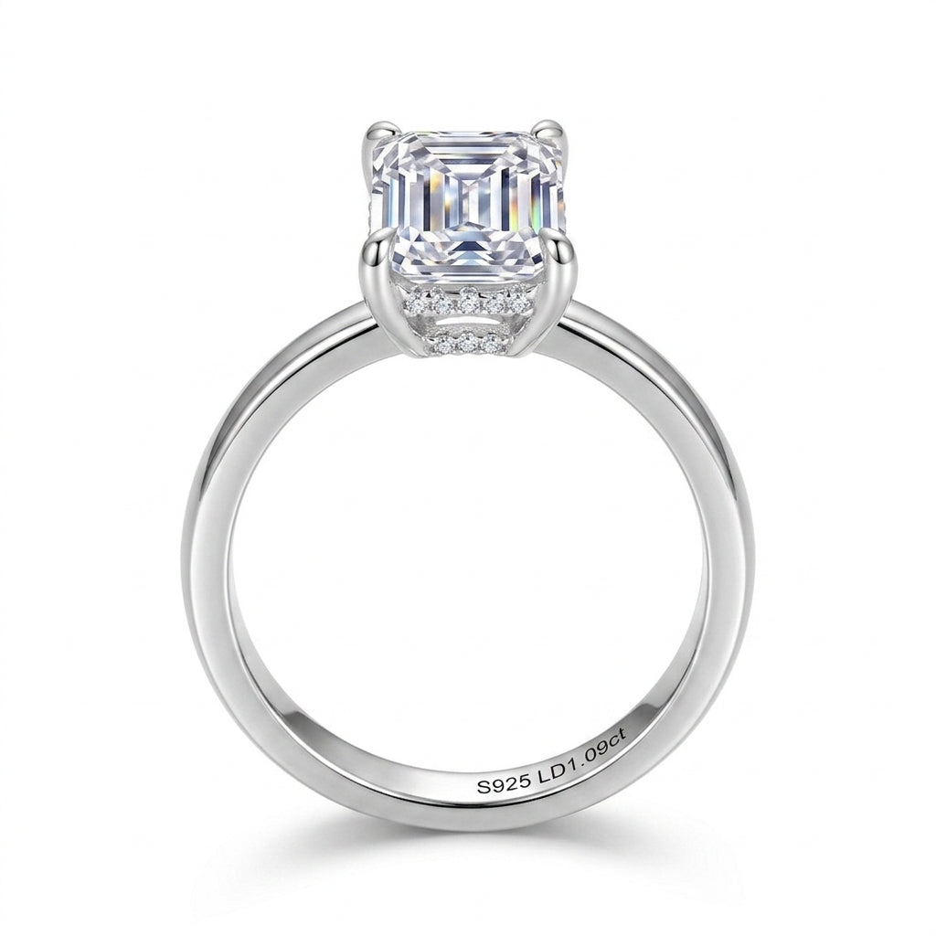 Straight-on view of emerald cut lab grown diamond ring showing hidden halo collar setting.