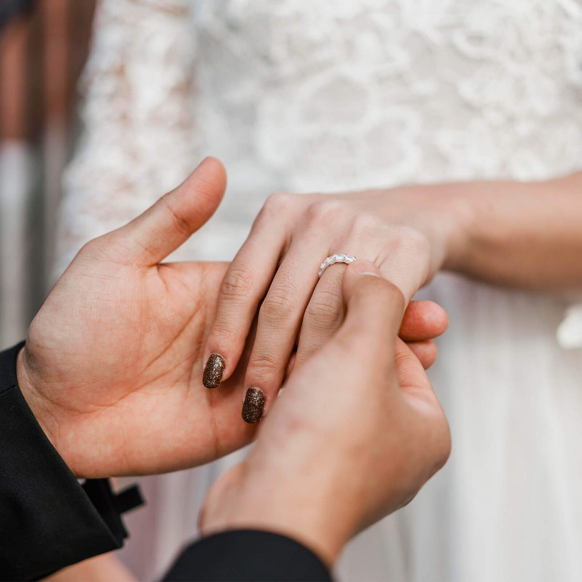 Wedding ceremony hand exchange with emerald cut lab diamond full eternity ring.