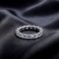 Perspective view of emerald cut lab diamond full eternity wedding band ring on dark silk.