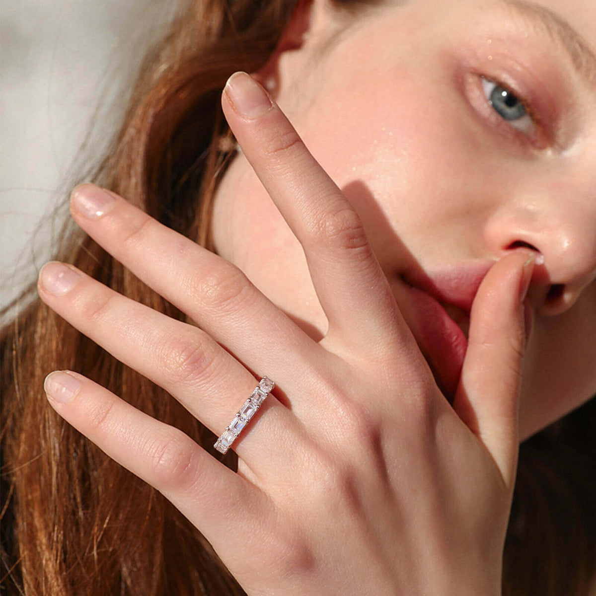 Model wearing emerald cut lab diamond full eternity wedding band ring.