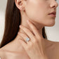 Close-up view of a model wearing minimalist emerald cut moissanite solitaire ring.
