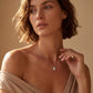 Model wearing emerald cut diamond octagonal halo bezel pendant necklace on collarbone.