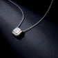 Emerald cut diamond solitaire pendant necklace displayed on dark background.