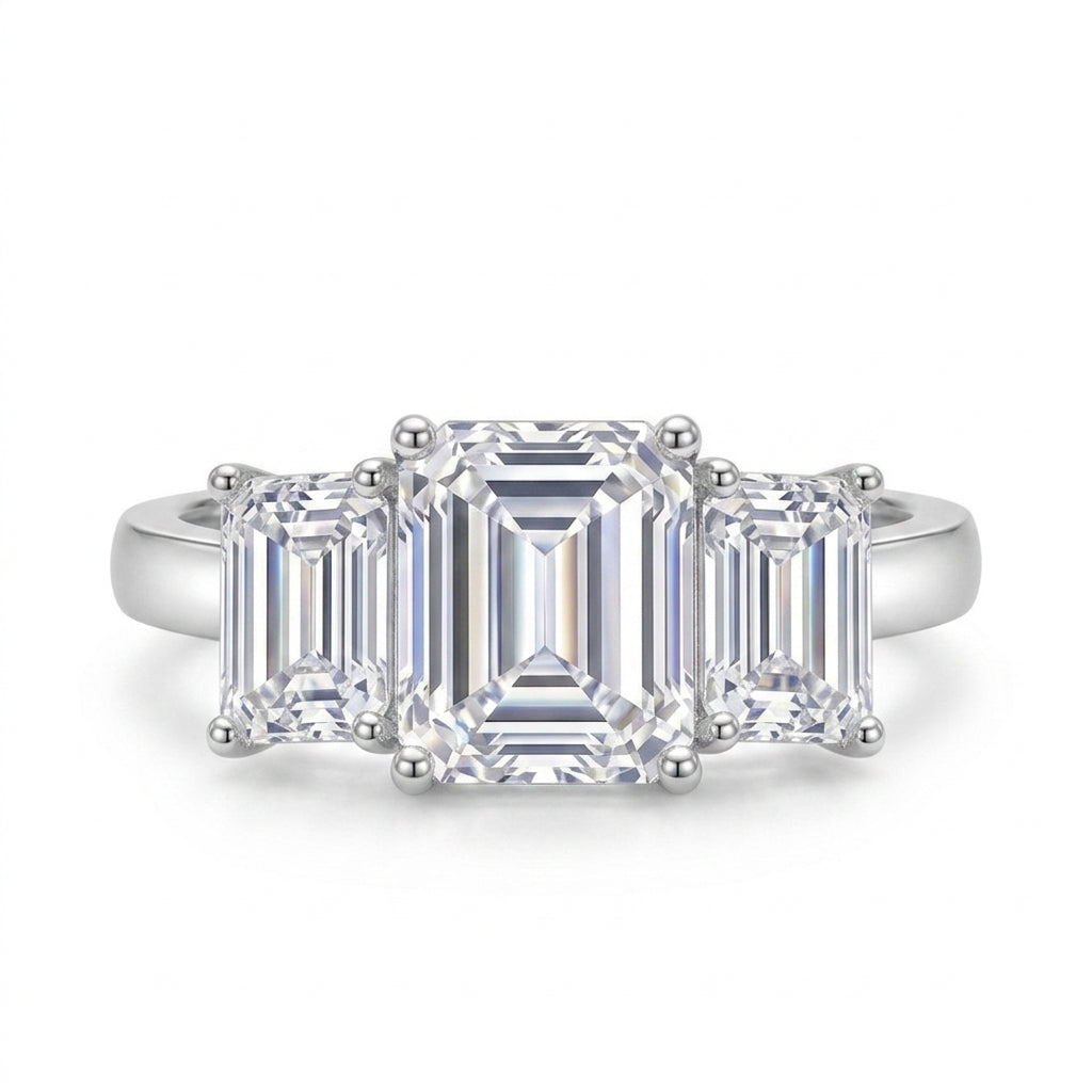 Direct top view showing graduated emerald cut three stone ring layout.