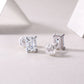 Side profile view showing basket setting and silicone backs on emerald cut moissanite studs.